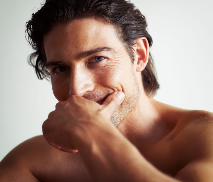 You could lose yourself in his eyes. Portrait of a handsome man with his hand covering his mouth